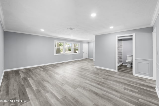 2155 Diana Dr, Palatka, FL 32177 - unfurnished living room featuring ornamental molding, recessed lighting, wood finished floors, and baseboards