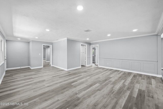 2155 Diana Dr, Palatka, FL 32177 - unfurnished room featuring recessed lighting, wood finished floors, ornamental molding, baseboards, and wainscoting