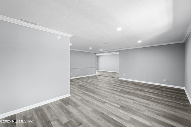 2155 Diana Dr, Palatka, FL 32177 - empty room featuring recessed lighting, ornamental molding, wood finished floors, baseboards, and a textured ceiling