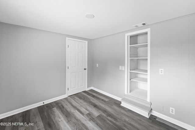 2155 Diana Dr, Palatka, FL 32177 - unfurnished bedroom with dark wood-style flooring and baseboards