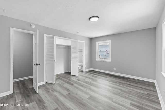 2155 Diana Dr, Palatka, FL 32177 - unfurnished bedroom with a closet, baseboards, and wood finished floors
