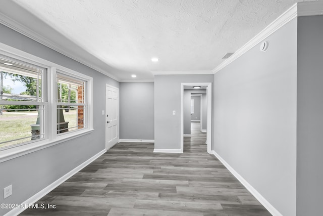 2155 Diana Dr, Palatka, FL 32177 - spare room with crown molding, a textured ceiling, baseboards, recessed lighting, and wood finished floors