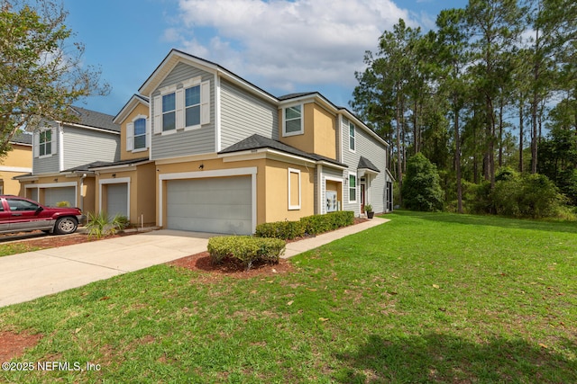 8609 Victoria Falls Dr, Jacksonville, FL 32244 - townhome / multi-family property with a garage, concrete driveway, a front yard, and stucco siding