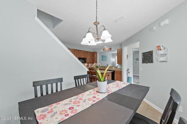 8609 Victoria Falls Dr, Jacksonville, FL 32244 - dining area featuring a chandelier, tile patterned floors, a textured ceiling, and baseboards