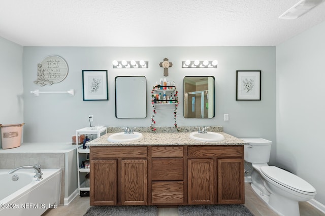 8609 Victoria Falls Dr, Jacksonville, FL 32244 - full bath with tile patterned floors, double vanity, a garden tub, toilet, and a textured ceiling