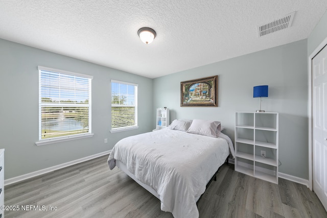 8609 Victoria Falls Dr, Jacksonville, FL 32244 - bedroom with wood finished floors, baseboards, and a textured ceiling