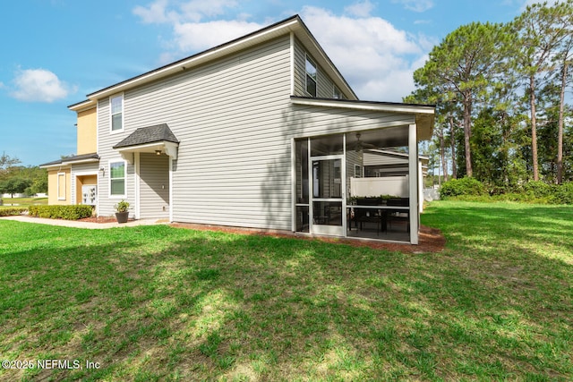 8609 Victoria Falls Dr, Jacksonville, FL 32244 - back of house with a sunroom and a yard