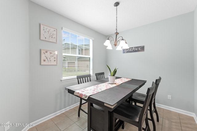 8609 Victoria Falls Dr, Jacksonville, FL 32244 - dining space featuring a chandelier, light tile patterned floors, and baseboards