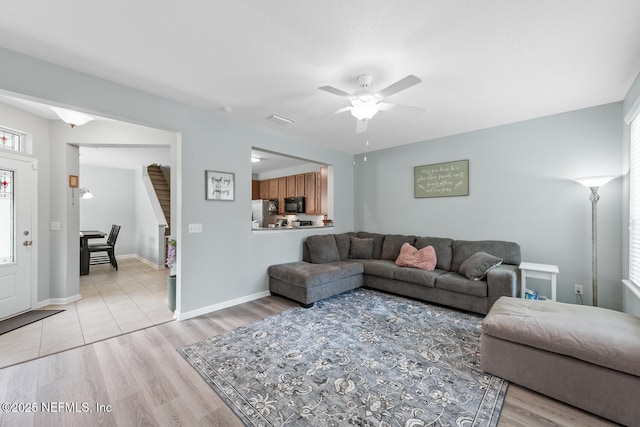 8609 Victoria Falls Dr, Jacksonville, FL 32244 - living room featuring a ceiling fan, light wood-style flooring, and baseboards