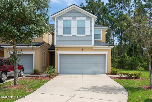 8609 Victoria Falls Dr, Jacksonville, FL 32244 - view of front facade with stucco siding, a garage, a shingled roof, and driveway