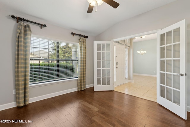 33146 Prairie Parke Pl, Fernandina Beach, FL 32034 - spare room with french doors, vaulted ceiling, a chandelier, wood finished floors, and ceiling fan