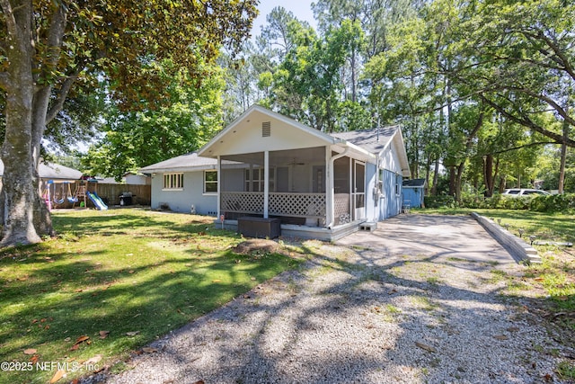 2780 Paul Ave, Jacksonville, FL 32207 - view of front of property featuring a sunroom, a playground, driveway, and a ceiling fan