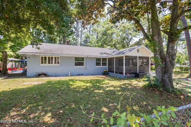 2780 Paul Ave, Jacksonville, FL 32207 - back of house with a sunroom, a lawn, concrete block siding, roof with shingles, and a chimney