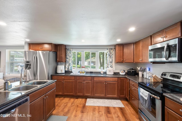 2780 Paul Ave, Jacksonville, FL 32207 - kitchen with stainless steel appliances, a sink, dark countertops, light wood-type flooring, and recessed lighting