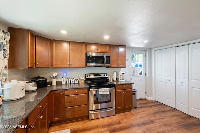 2780 Paul Ave, Jacksonville, FL 32207 - kitchen with appliances with stainless steel finishes, brown cabinets, light wood-style floors, and recessed lighting
