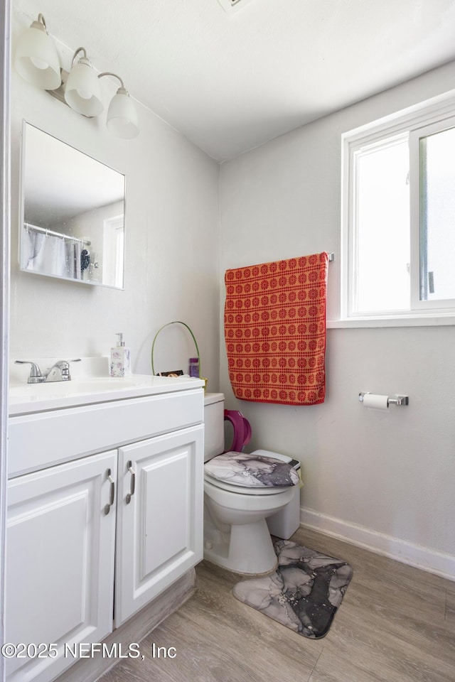 2780 Paul Ave, Jacksonville, FL 32207 - full bathroom with toilet, vanity, wood finished floors, and baseboards