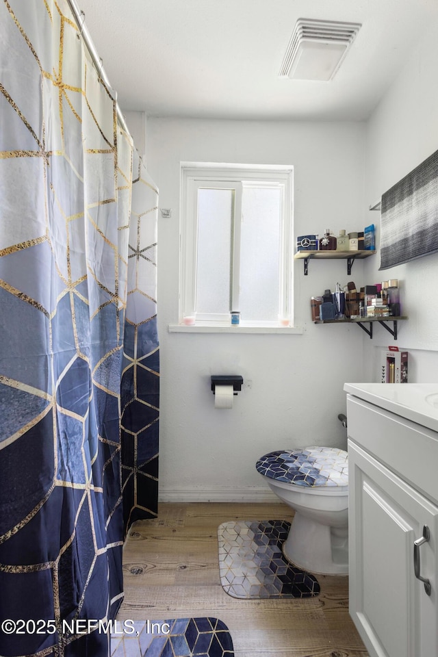 2780 Paul Ave, Jacksonville, FL 32207 - bathroom with vanity, toilet, wood finished floors, and a shower with curtain