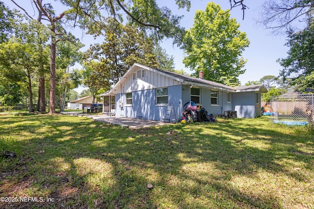 2780 Paul Ave, Jacksonville, FL 32207 - rear view of house with a chimney, board and batten siding, a patio area, and central AC