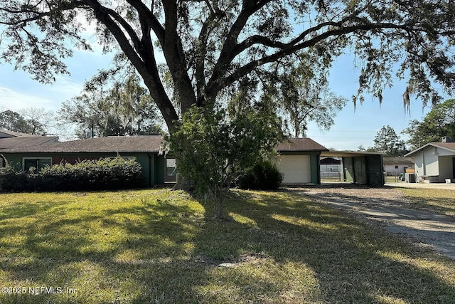 3446 NE 11th St, Ocala, FL 34470 - view of front facade featuring driveway, a front lawn, an attached garage, and a carport