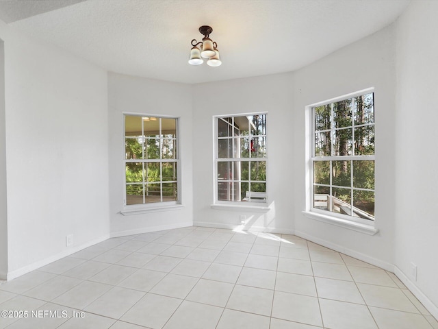 96092 Piney Island Dr, Fernandina Beach, FL 32034 - unfurnished dining area featuring a chandelier, tile patterned flooring, and baseboards