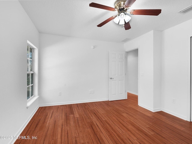 96092 Piney Island Dr, Fernandina Beach, FL 32034 - empty room with wood finished floors, ceiling fan, and baseboards
