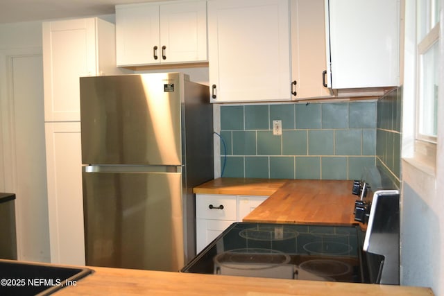 5466 Leonard St, Fernandina Beach, FL 32034 - kitchen featuring freestanding refrigerator, wooden counters, electric range, white cabinets, and tasteful backsplash