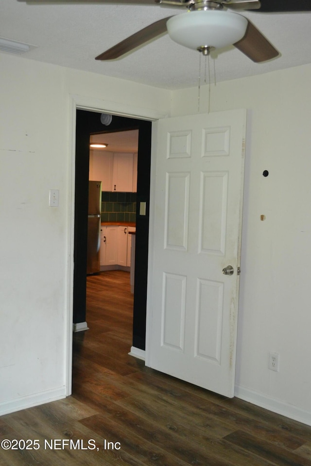 5466 Leonard St, Fernandina Beach, FL 32034 - empty room with a ceiling fan, dark wood-style flooring, and baseboards