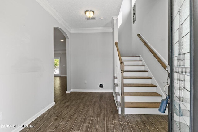 356 Heron Landing Rd, Saint Johns, FL 32259 - staircase with arched walkways, wood finished floors, baseboards, ornamental molding, and a textured ceiling