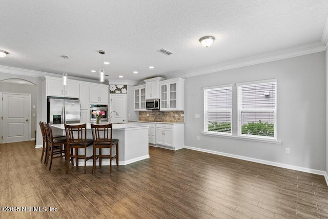 356 Heron Landing Rd, Saint Johns, FL 32259 - kitchen with appliances with stainless steel finishes, a sink, an island with sink, ornamental molding, and light countertops