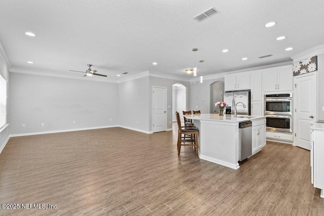 356 Heron Landing Rd, Saint Johns, FL 32259 - kitchen with arched walkways, appliances with stainless steel finishes, a sink, a ceiling fan, and light countertops