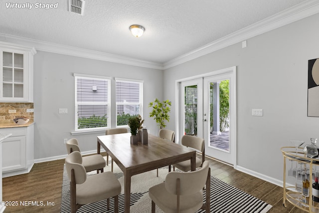 356 Heron Landing Rd, Saint Johns, FL 32259 - dining room with ornamental molding, dark wood finished floors, french doors, a textured ceiling, and baseboards