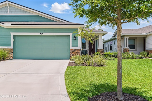 109 Fly Line Dr, Saint Johns, FL 32259 - view of front facade featuring stone siding, a front yard, driveway, and an attached garage