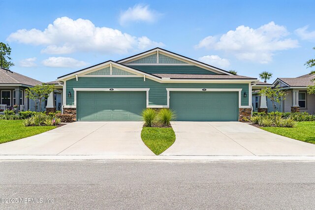 109 Fly Line Dr, Saint Johns, FL 32259 - craftsman-style house featuring stone siding, concrete driveway, and a garage