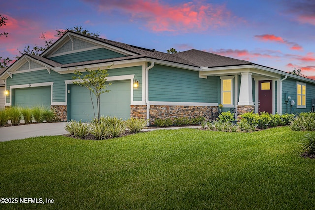 109 Fly Line Dr, Saint Johns, FL 32259 - craftsman house featuring stone siding, an attached garage, a lawn, concrete driveway, and a shingled roof