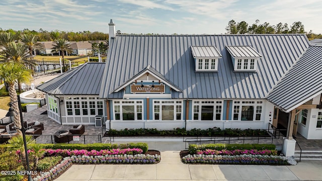 109 Fly Line Dr, Saint Johns, FL 32259 - back of property featuring metal roof, a chimney, a patio area, and a standing seam roof