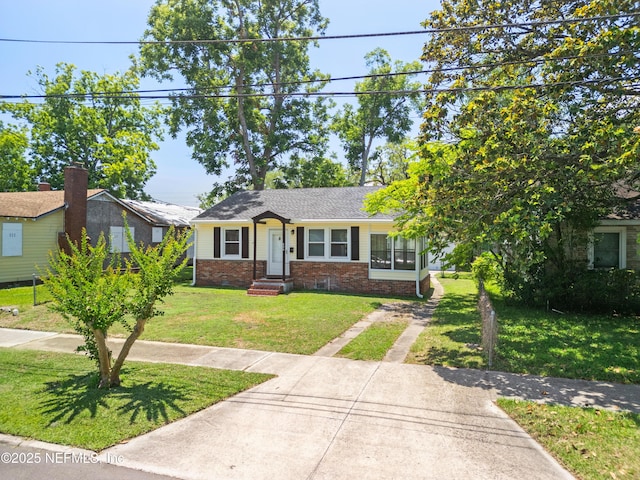 606 Meteor St, Jacksonville, FL 32205 - view of front of property featuring brick siding, a front yard, and driveway