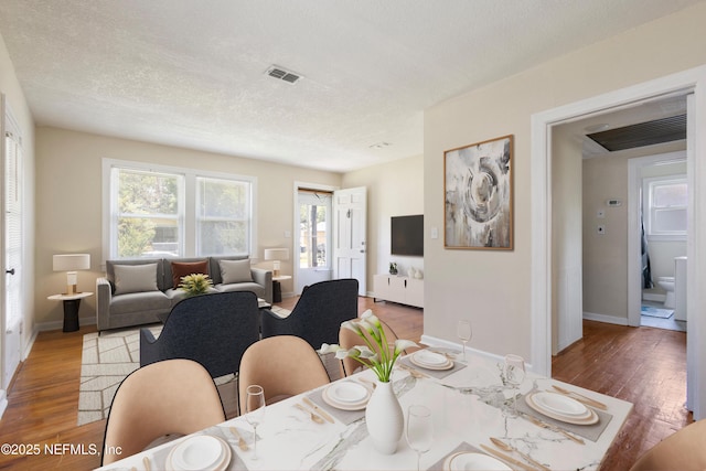 606 Meteor St, Jacksonville, FL 32205 - dining space featuring wood finished floors, baseboards, and a textured ceiling