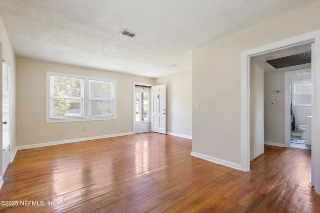 606 Meteor St, Jacksonville, FL 32205 - spare room featuring wood finished floors, a textured ceiling, and baseboards