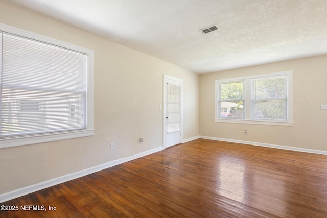 606 Meteor St, Jacksonville, FL 32205 - spare room with wood finished floors, baseboards, and a textured ceiling