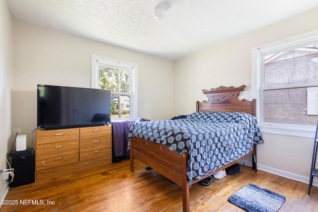 606 Meteor St, Jacksonville, FL 32205 - bedroom featuring wood finished floors, a textured ceiling, and baseboards