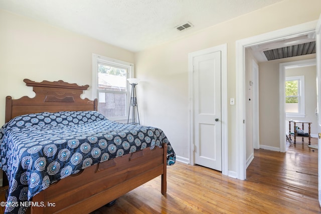 606 Meteor St, Jacksonville, FL 32205 - bedroom featuring wood finished floors, multiple windows, and baseboards