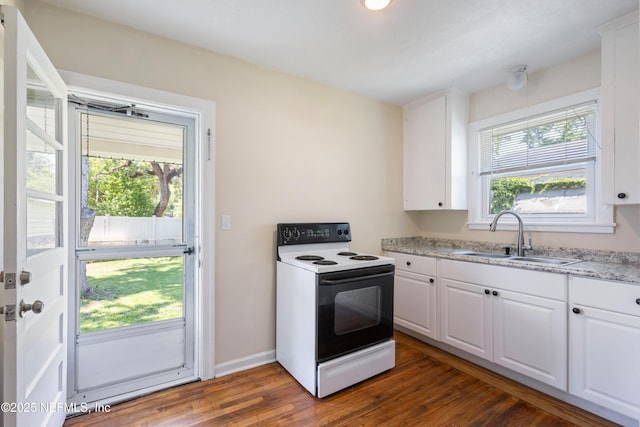 606 Meteor St, Jacksonville, FL 32205 - kitchen with electric range, a sink, dark wood finished floors, white cabinetry, and baseboards