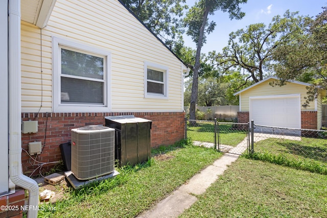 606 Meteor St, Jacksonville, FL 32205 - view of home's exterior with central AC, brick siding, driveway, and a detached garage
