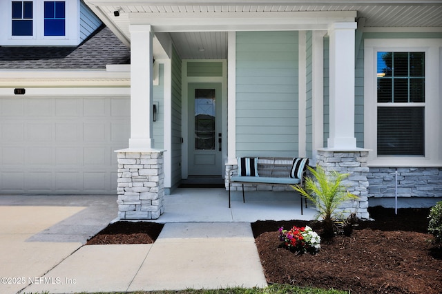 91 Rockhurst Trl, Jacksonville, FL 32081 - doorway to property with a porch, stone siding, roof with shingles, an attached garage, and concrete driveway