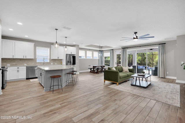 91 Rockhurst Trl, Jacksonville, FL 32081 - living room featuring ceiling fan, healthy amount of natural light, light wood-style flooring, baseboards, and recessed lighting