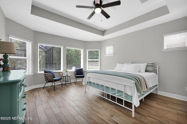 91 Rockhurst Trl, Jacksonville, FL 32081 - bedroom with a raised ceiling, multiple windows, wood finished floors, and baseboards