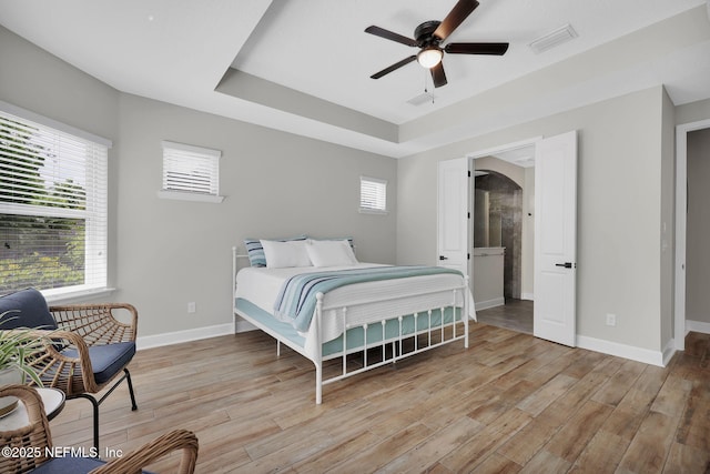 91 Rockhurst Trl, Jacksonville, FL 32081 - bedroom with light wood finished floors, arched walkways, baseboards, and a raised ceiling