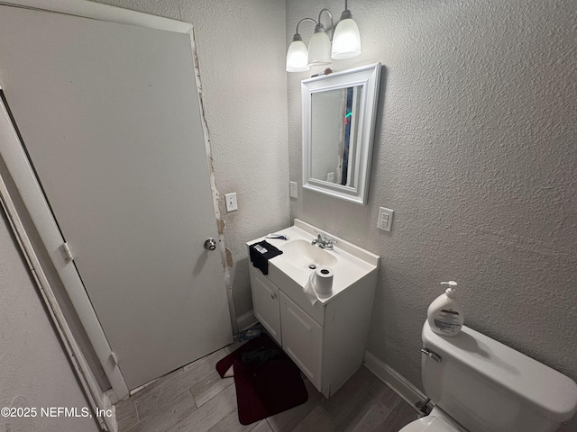 5362 Shen Ave, Jacksonville, FL 32205 - bathroom featuring wood finished floors, vanity, a textured wall, and toilet