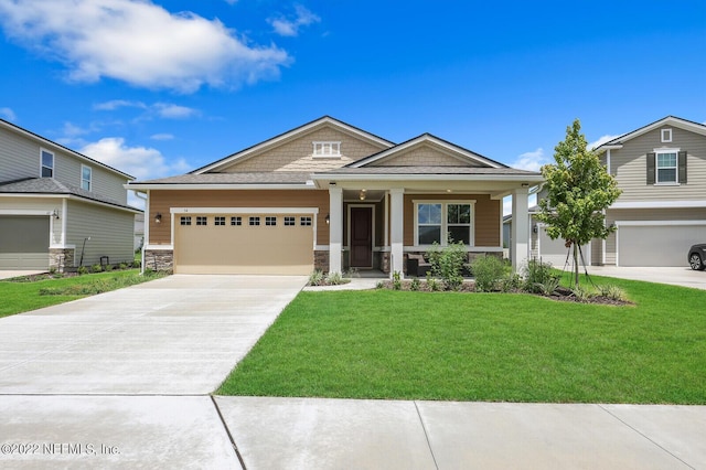 54 Pepperpike Way, Saint Augustine, FL 32092 - craftsman-style house with driveway, a front lawn, a garage, stone siding, and covered porch