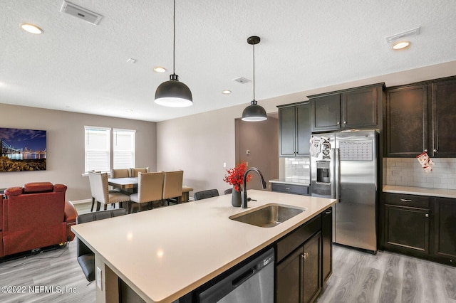 54 Pepperpike Way, Saint Augustine, FL 32092 - kitchen featuring a sink, appliances with stainless steel finishes, light wood-type flooring, light countertops, and a textured ceiling